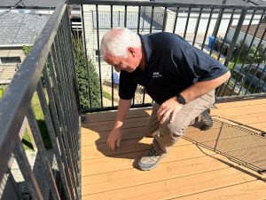 Townhouse deck and fencing being inspected for spring repairs.