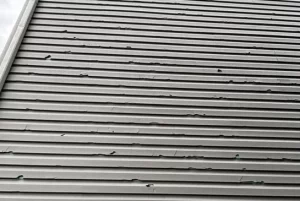 Close‑up of siding damage on a townhouse exterior.
